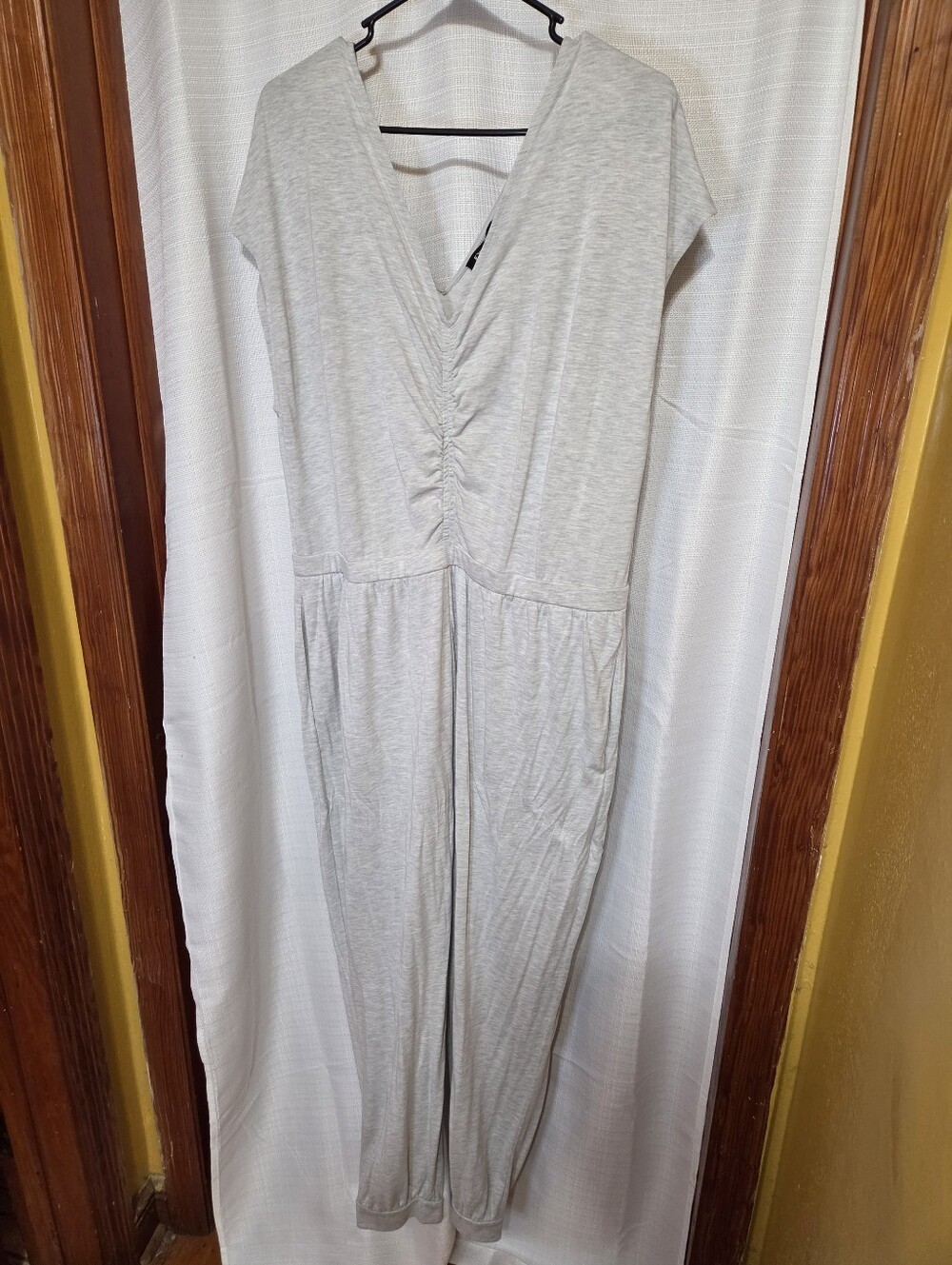 Express heather knit lounge jumpsuit featuring a cinched V-neck and jogger-style